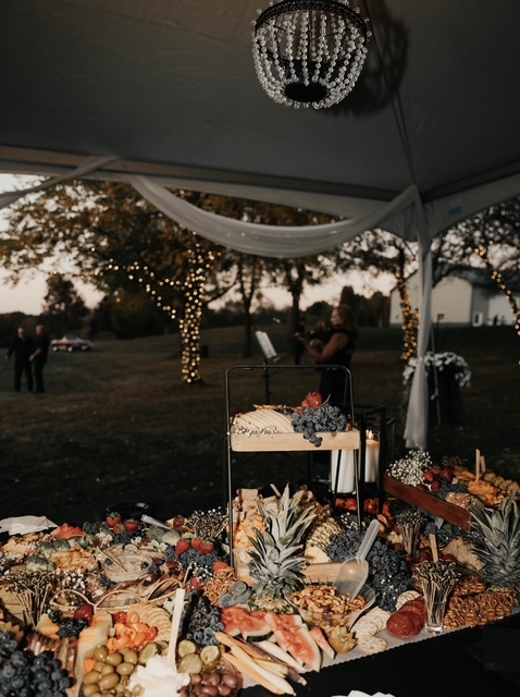 Outdoor wedding reception tent with warm string lighting